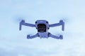 Dji Mavic Mini 2 drone flying in purple cloudy sky