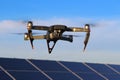 DJI Mavic Pro drone in flight above solar panels