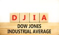 DJIA Dow Jones industrial average symbol. Concept words DJIA Dow Jones industrial average on wooden block on beautiful white