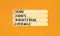DJIA Dow Jones industrial average symbol. Concept words DJIA Dow Jones industrial average on wooden stick on beautiful orange