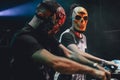 Djs with mexican masks playing mixing music at party festival. Fun, youth, entertainment and fest concept Royalty Free Stock Photo