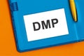 DMP Dept Management Plan, word on paper. The DMP label on the business card from the daily planner