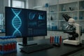 DNA analysis on a computer screen in a laboratory with a microscope and test tubes science research Royalty Free Stock Photo
