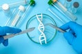 DNA helix research. Concept of genetic experiments on human biological code. Medical instrument scalpel and forceps and test tubes Royalty Free Stock Photo