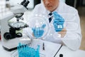 DNA molecule testing concepts. The doctor in a mask examines DNA molecules on the chemical laboratory with virtual icon Royalty Free Stock Photo