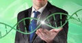 Dna structure over mid section of business man with cupped hand against green background Royalty Free Stock Photo