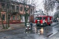 Dnepr, Ukraine - December 14, 2017: Two firemen from the rescue service connect the water hoses to extinguish the fire. Water jets