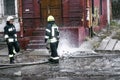 Dnepr, Ukraine - December 14, 2017: Two firemen from the rescue service connect the water hoses to extinguish the fire. Water jets