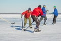 Group of ordinary people playing hockey on a frozen river Dnepr in Ukraine