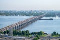 Dnepr, Ukraine - June 07, 2018: The barge sails under the central bridge of the city. City landscape from a height. The traffic