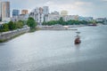 Dnepr, Ukraine - May 16, 2017: A sailing ship with passengers rides along a wide river in the background of a large city. City