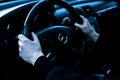 Car Mercedes-Benz R 350. Woman driving a car. Women`s hands hold the steering wheel