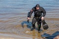 Professional diver near the river coastline. Commercial diving. Winter