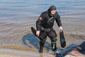 Professional diver near the river coastline. Commercial diving. Winter