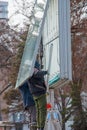 Installation of outdoor advertising in the city. Specialists climb the stairs to the billboard. Work at height