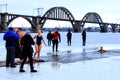 Winter sports, Hardening. People swimming in the river holes in the supervision of rescuers in uniform and wetsuits.