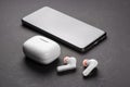 Dnipo, Ukraine, february 20, 2023: JBL Tune 230 NC TWS headphones. Closeup modern headphone with case and smartphone