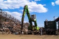 Dnipro, Dnepropetrovsk region / Ukraine - 01/10/2019; Loading scrap metal into wagons with a hydraulic manipulator.