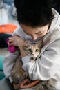 Dnipro, Ukraine - April 04, 2022: Woman hugging her cat