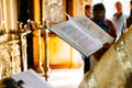 christian priest reading church book, priest reads a pray over the Bible