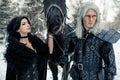 Cosplayers in image of a characters Geralt of Rivia and Yennefer of Vengerberg from the game or film The Witcher next to a horse