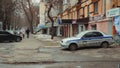 A security vehicle with a SOBR guard is parked at the entrance to a dry-cleaner. A man and woman are walking down the street hold