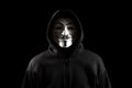Dnipro. Ukraine 31 jan 2024: Man wearing vendetta mask with hoodie on black background
