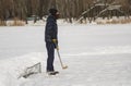 Amateur man playing hockey as a goalkeeper standing against tiny gates