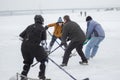 Brave neenager girl attacking small goal that mature men defending while playing hockey