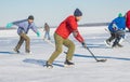 Group of different ages ordinary people playing hockey on a river Dnipro in Ukraine