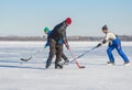 Group of mature men playing hockey on a river Dnipro in Ukraine