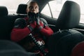 DNIPRO, UKRAINE - MARCH 28, 2019: Deadpool cosplayer posing in the car