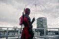 DNIPRO, UKRAINE - MARCH 28, 2019: Deadpool cosplayer posing with weapon and umbrella