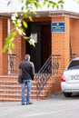 A man near the entrance to the office of the Department of Landscaping and Infrastructure of the Dniprovsky City Council Royalty Free Stock Photo