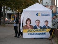 Dnipro, Ukraine - October 23, 2020: Agitators hand out leaflets at campaign cubes ahead of parliamentary elections. Lady with