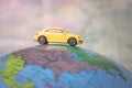Dnipro, Ukraine - October 03, 2019: The concept of travel around the world on a passenger auto. A yellow toy car is traveling Royalty Free Stock Photo