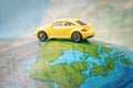 Dnipro, Ukraine - October 03, 2019: A yellow toy car is traveling around the globe. The car is located on the American continent Royalty Free Stock Photo