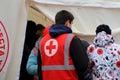Dnipro Ukraine. Red Cross volunteers help wounded near destroyed house after Russian missile attack. Red cross badge on uniform of Royalty Free Stock Photo