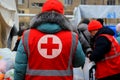 Dnipro Ukraine. Red Cross volunteers help wounded near destroyed house after Russian missile attack. Red cross badge on uniform of