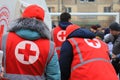 Dnipro Ukraine. Red Cross volunteers help wounded near destroyed house after Russian missile attack. Red cross badge on uniform of