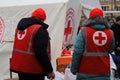 Dnipro Ukraine. Red Cross volunteers help wounded near destroyed house after Russian missile attack. Red cross badge on uniform of Royalty Free Stock Photo