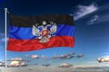 Dnr national flag waving in the wind against deep blue sky. International relations concept