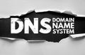 DNS Domain Name System concept torn paper style. Technology and internet infrastructure term related to web hosting, networking, Royalty Free Stock Photo