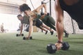 Do as many reps as you can. a fitness group using dumbbells while doing push-ups at the gym. Royalty Free Stock Photo