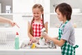 Do the dishes - kids ordered to help in the kitchen Royalty Free Stock Photo