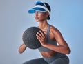Do it for those gorgeous glutes. Studio shot of a fit young woman working out with a medicine ball against a grey Royalty Free Stock Photo