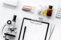 Do medcal tests. Microscope, tablet, pills and test tube on white background top view Royalty Free Stock Photo