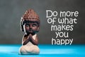 Do more of what makes you happy - inspirational background with white statuette of Buddha. Yoga and meditation concept