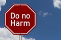 Do no harm message on red street stop sign