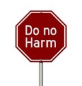 Do no harm message on red street stop sign